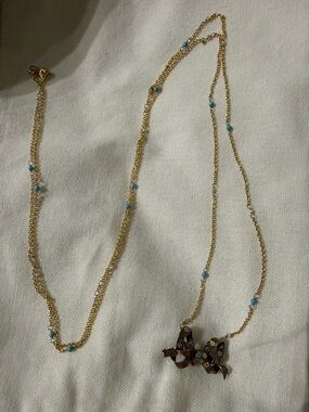 Gold Tone Necklace with Turquoise Beads and Decorative Bow Pendant